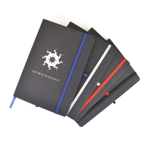 Pile of black branded eco-friendly notebooks with coloured elastic closure strap and pen loop